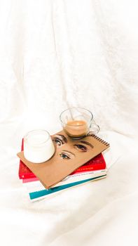 Artistic flat lay of coffee, books, and milk creating a cozy reading vibe.