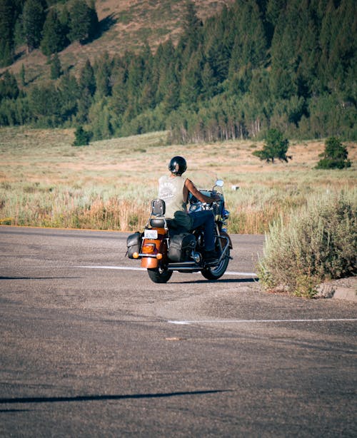 A Man Riding a Motorcycle on the Road