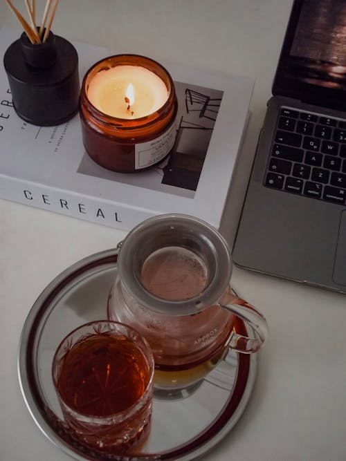 Coffee in Glass and Candle on Table