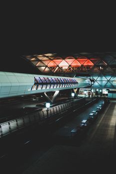 A nighttime scene showcasing modern architecture of an illuminated airport terminal.