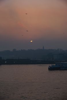 Serene sunset over Bosphorus in Istanbul, capturing the city's silhouette and serene waters.