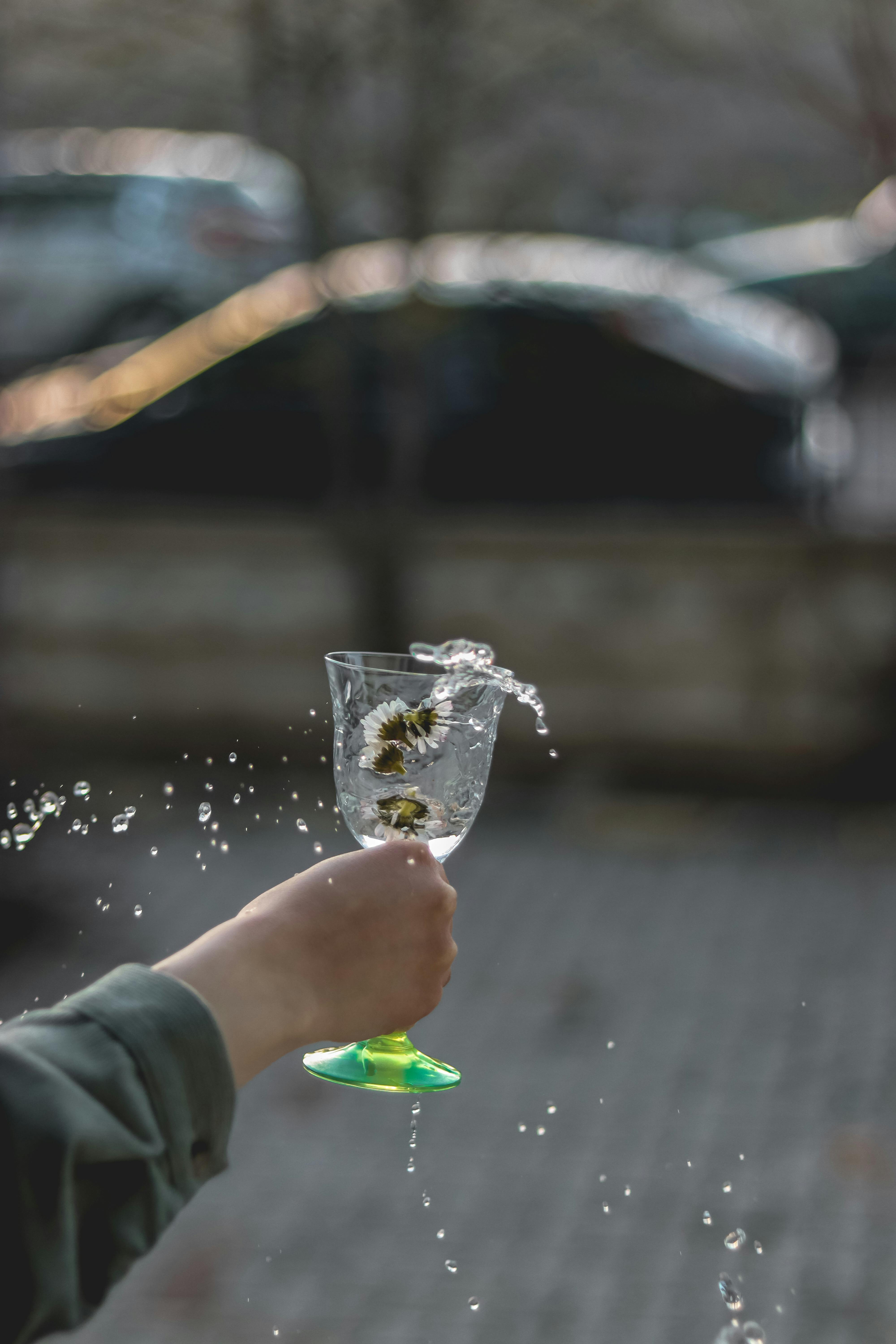 Person Splashing Drink from Glass · Free Stock Photo