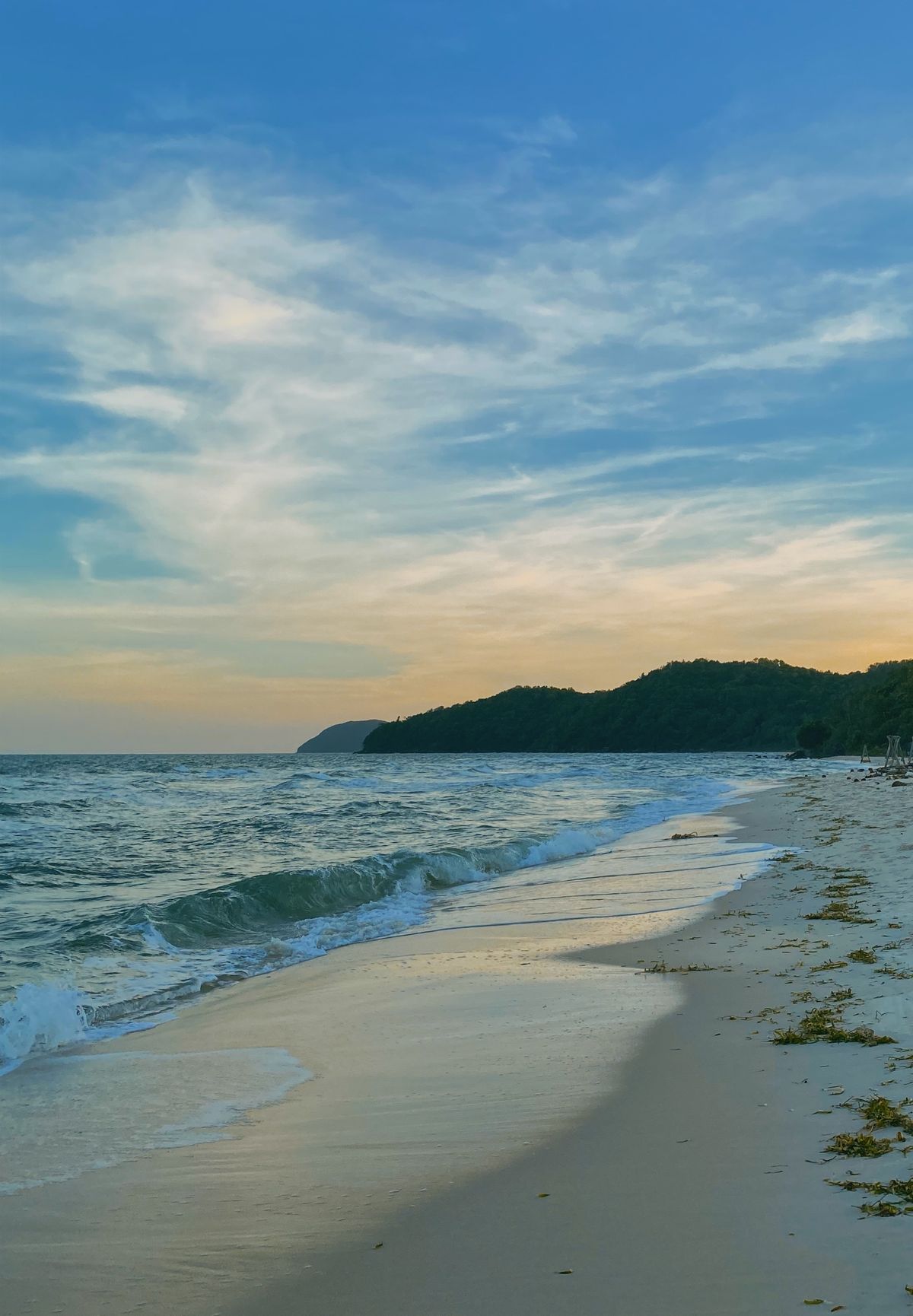 Waves washing onto a Phu Quoc beach in soft evening light