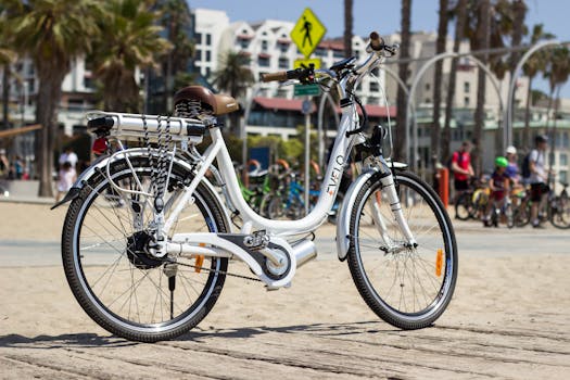Electric bike parked on a sunny beach in Los Angeles, perfect for city exploration.