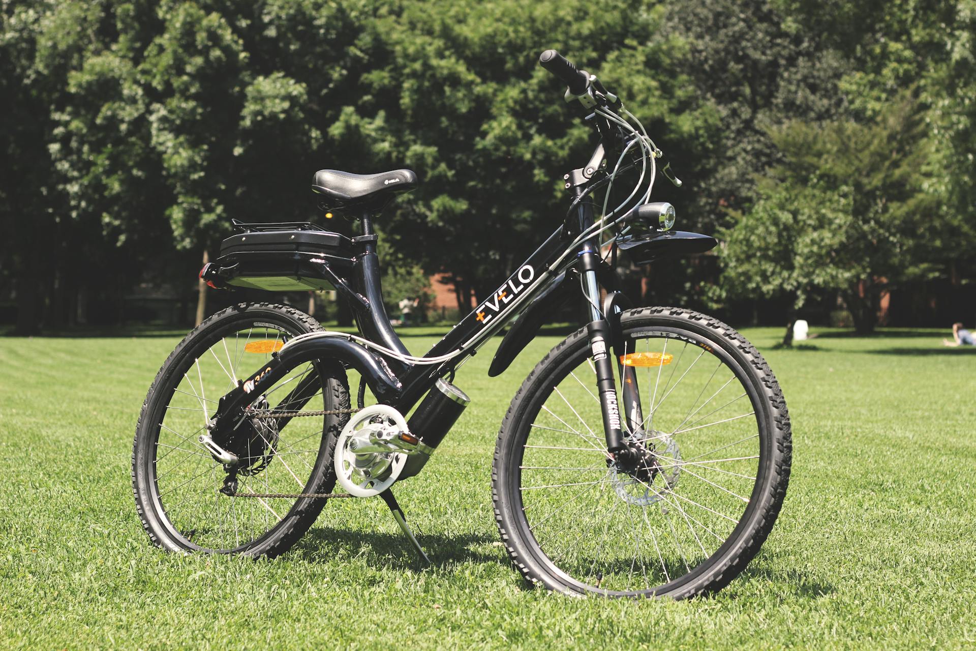 A black and white electric bike sitting in the grass
