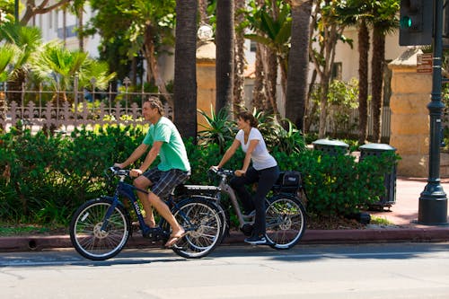 Man in Green Shirt and a Woman Riding Bicycles