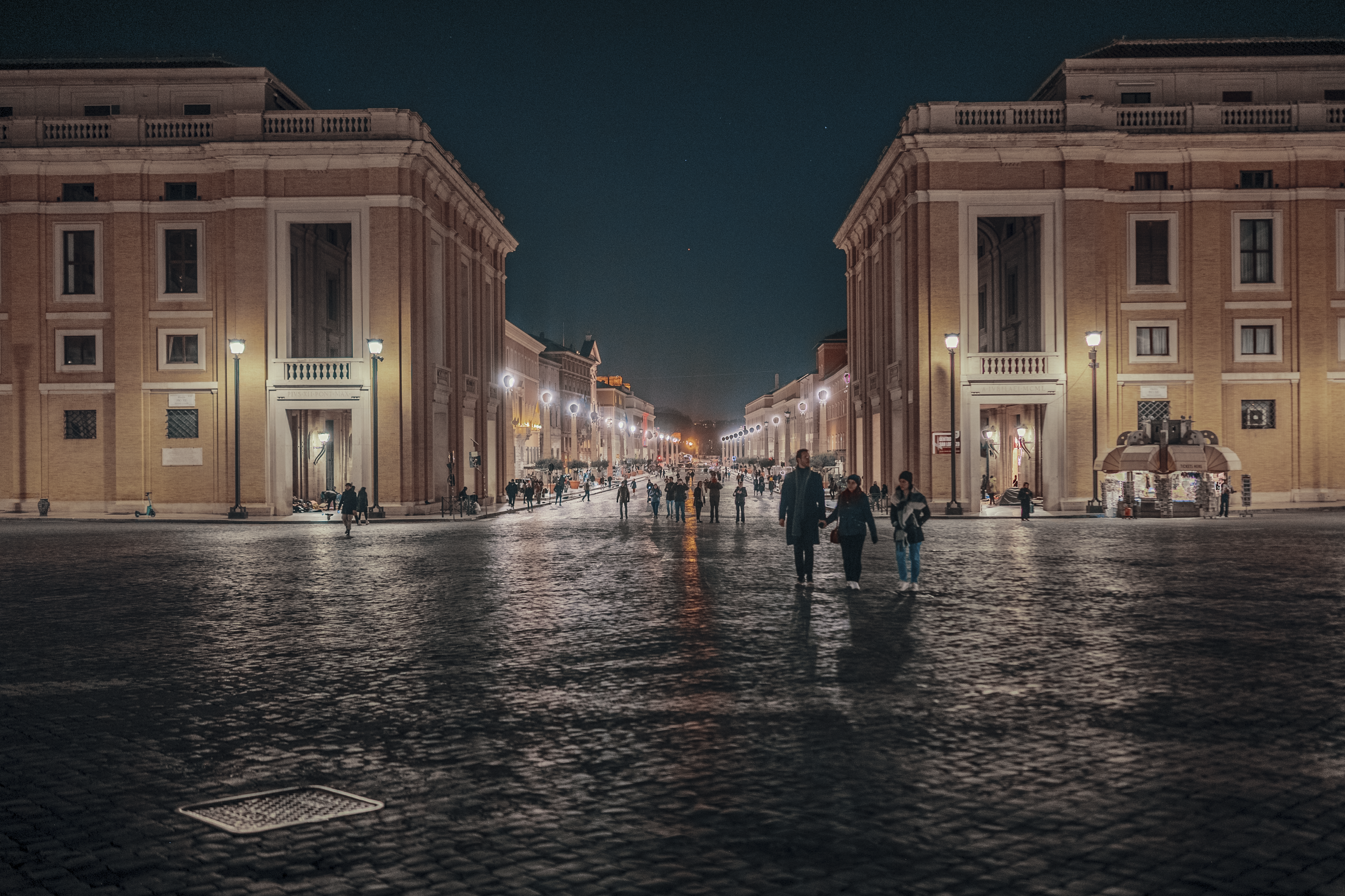 Lively evening scene in Trastevere, Rome, with restaurants and people