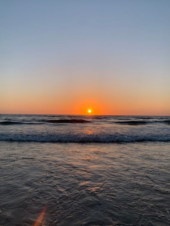 Sun Setting on Horizon above Sea · Free Stock Photo