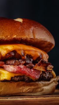 Close-up of a delicious cheeseburger with crispy bacon and melted cheese, perfect for fast food lovers.