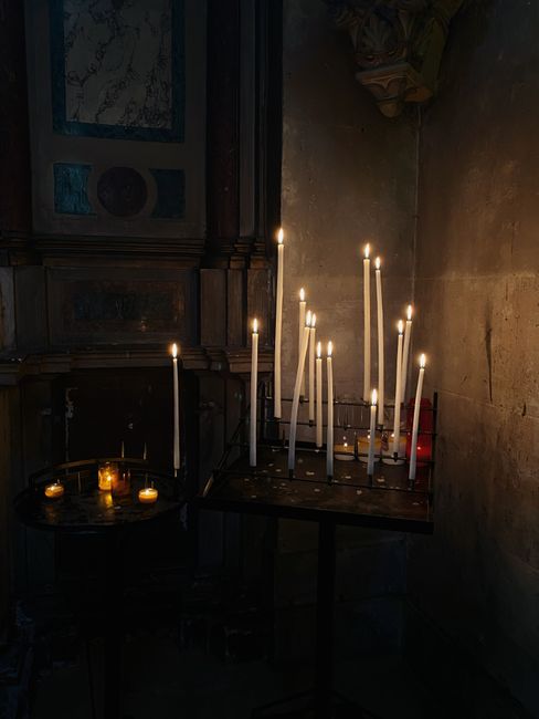 Warm candlelit ambience in a quiet corner of a historic Paris church. Perfect for contemplative moments.