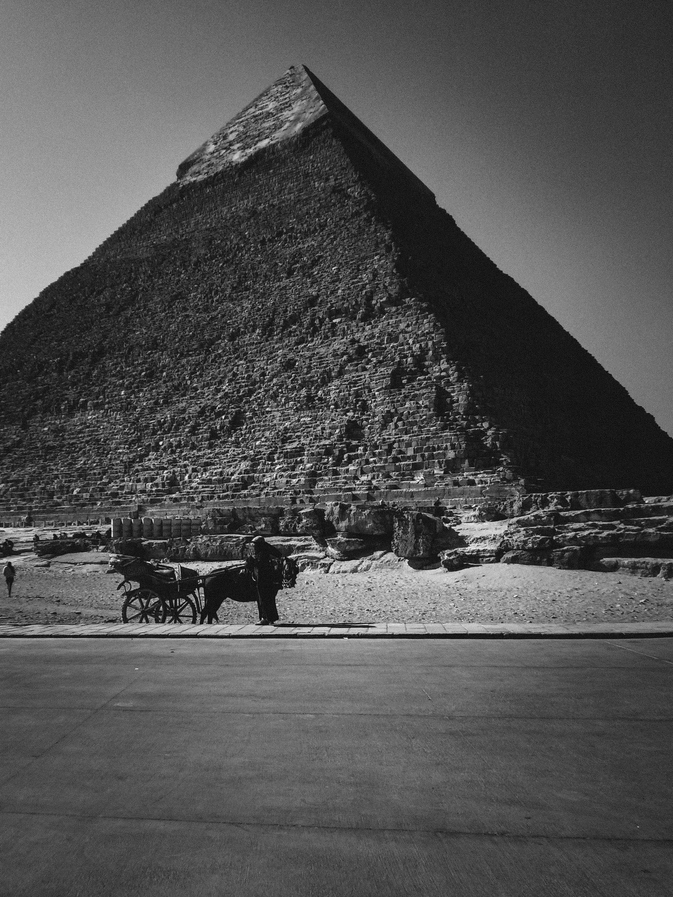 a black and white photo of a large pyramid