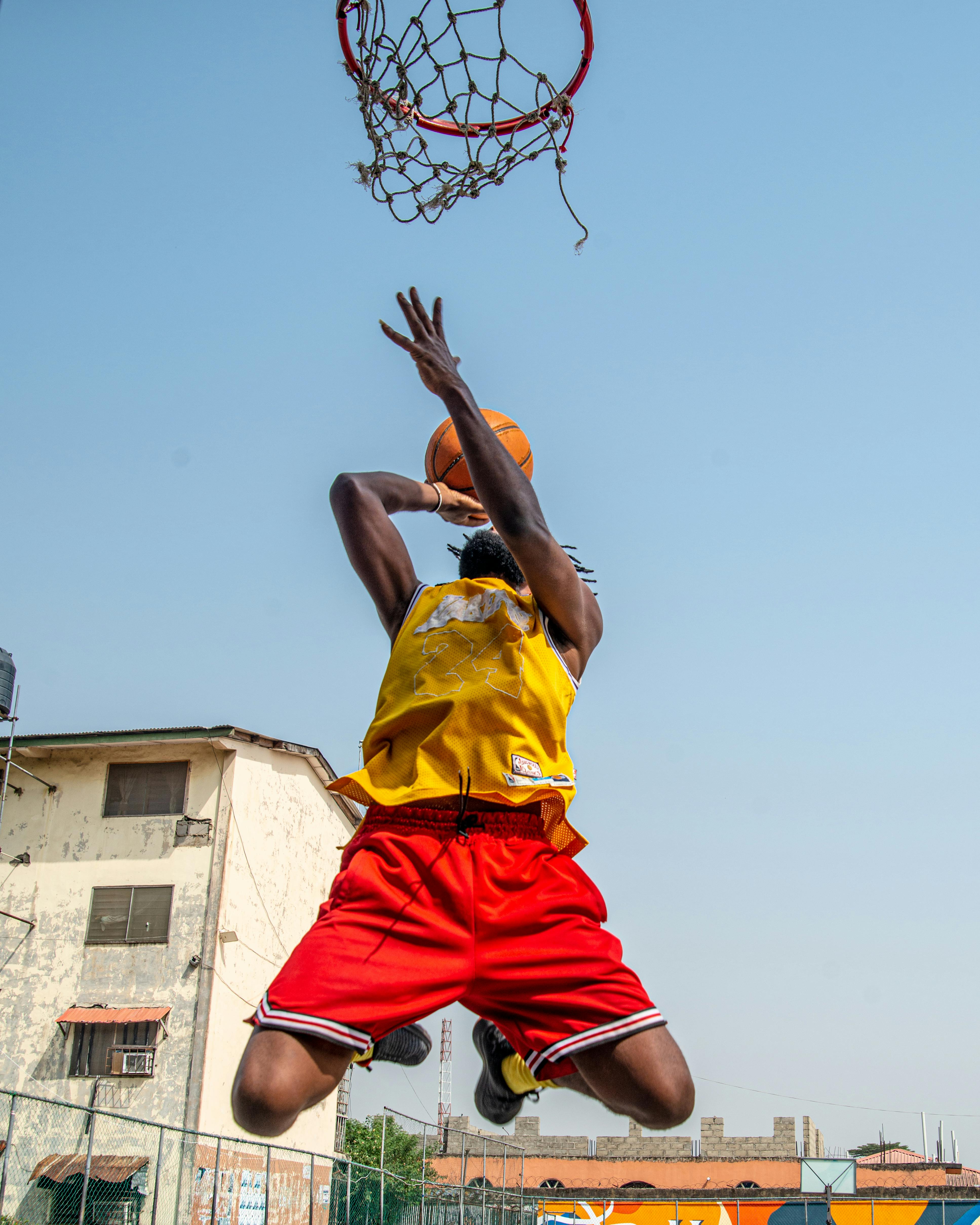 Download A Basketball Player Is Dunking Wallpaper