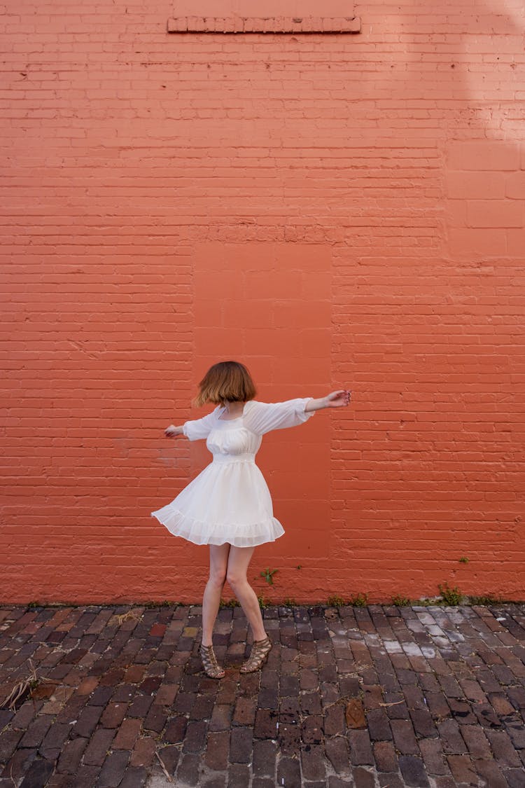 A Woman In A White Dress Spinning