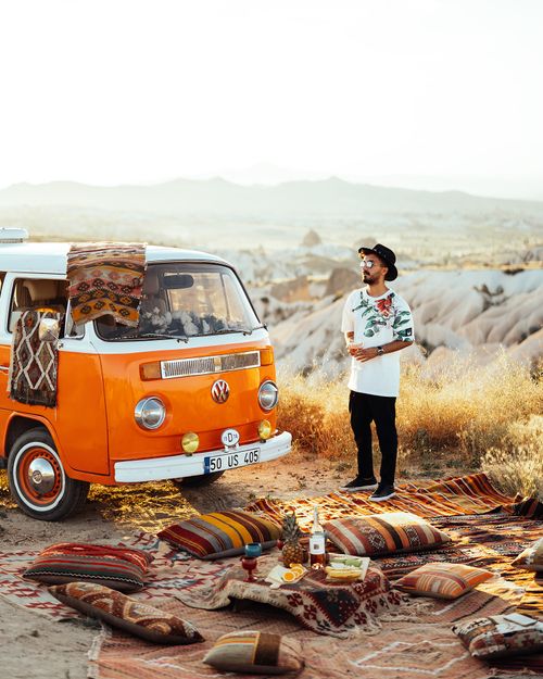 Free Explore a vintage camper van adventure amidst Cappadocia's stunning landscape at sunrise. Stock Photo