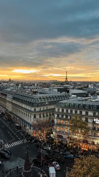 Stunning view of Paris cityscape featuring Eiffel Tower and beautiful sunset skies, urban elegance at its best.