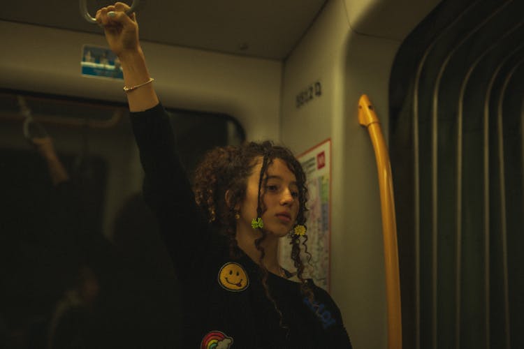 A Girl Standing Inside A Train