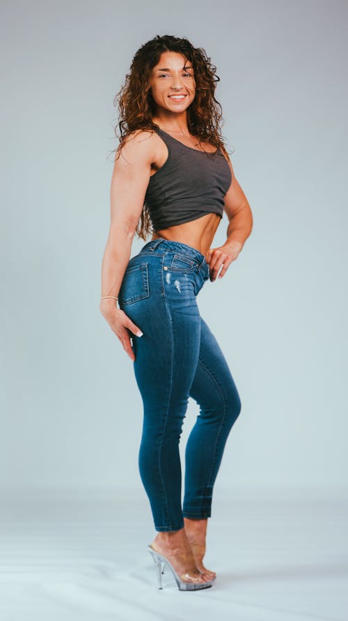 A Muscular Woman Standing while Posing at the Camera