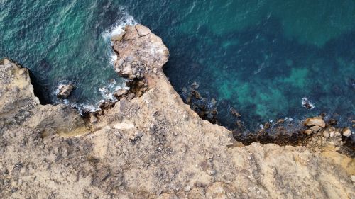 Free Stunning aerial view of a rugged coastline with turquoise waters in Angola. Stock Photo