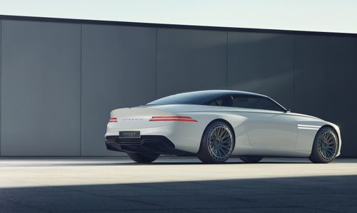 Free Sleek white Genesis car in a minimalist outdoor environment, showcasing modern automotive design. Stock Photo