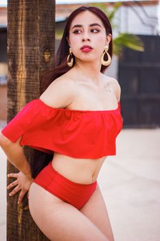Woman posing in a vibrant red bikini outdoors in Ciudad Juárez, Mexico.