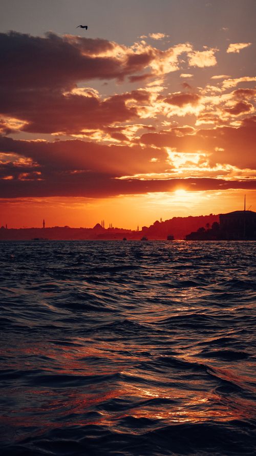 Free A captivating sunset view over the Bosphorus Strait in Istanbul, Turkey, with a vibrant sky and silhouette skyline. Stock Photo