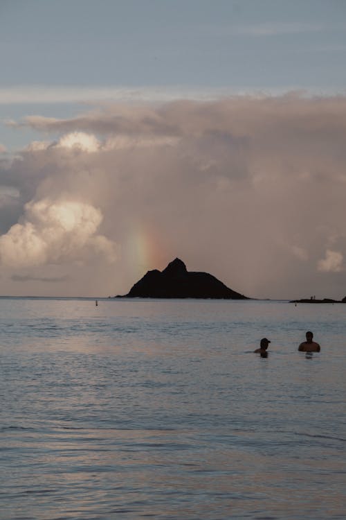 People Swimming on Sea Shore