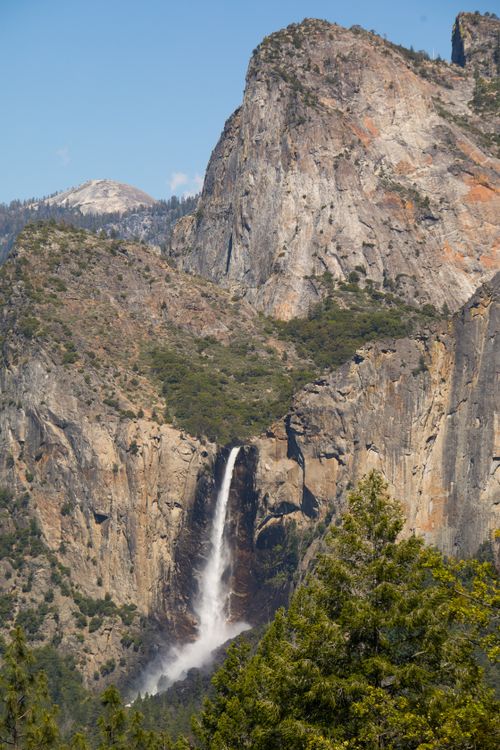 Free A stunning view of Bridalveil Fall cascading down in Yosemite National Park with towering cliffs. Stock Photo