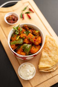 Top view of a flavorful Nepalese curry with fresh roti, showcasing vibrant spices and local ingredients.