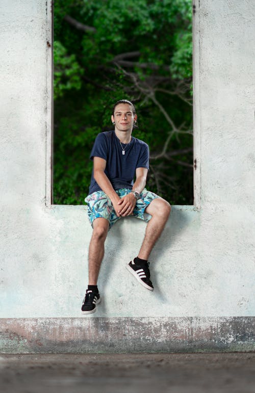 Teenager Sitting on the Old Windowsill