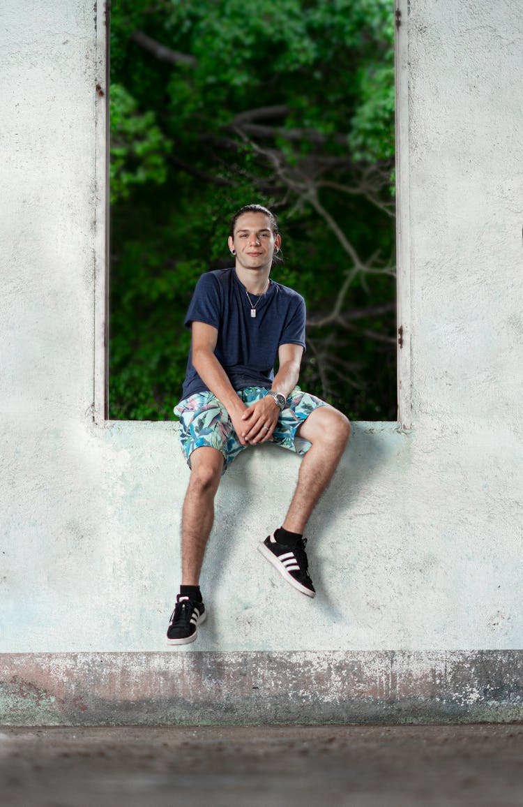 Teenager Sitting On The Old Windowsill