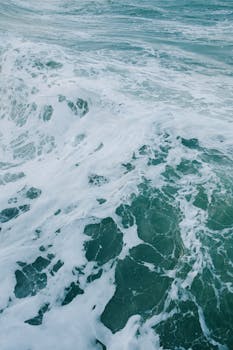 Vibrant ocean waves crashing turbulently, capturing nature's raw energy and motion.