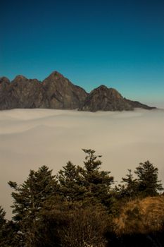 Captivating view of mountains and fog, offering a serene and majestic landscape.