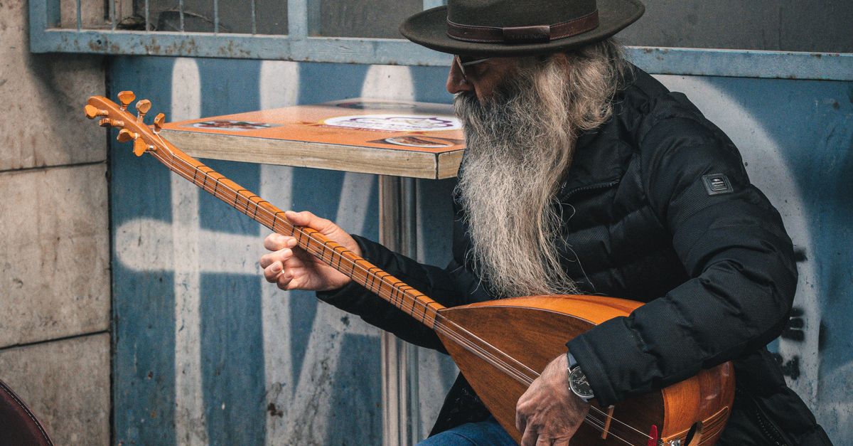 A Man Playing a Musical Instrument in a City · Free Stock Photo