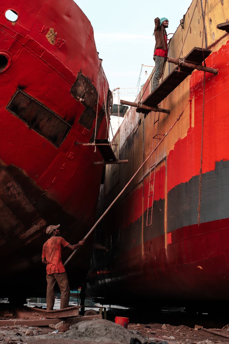 Men Painting A Ship On Docked