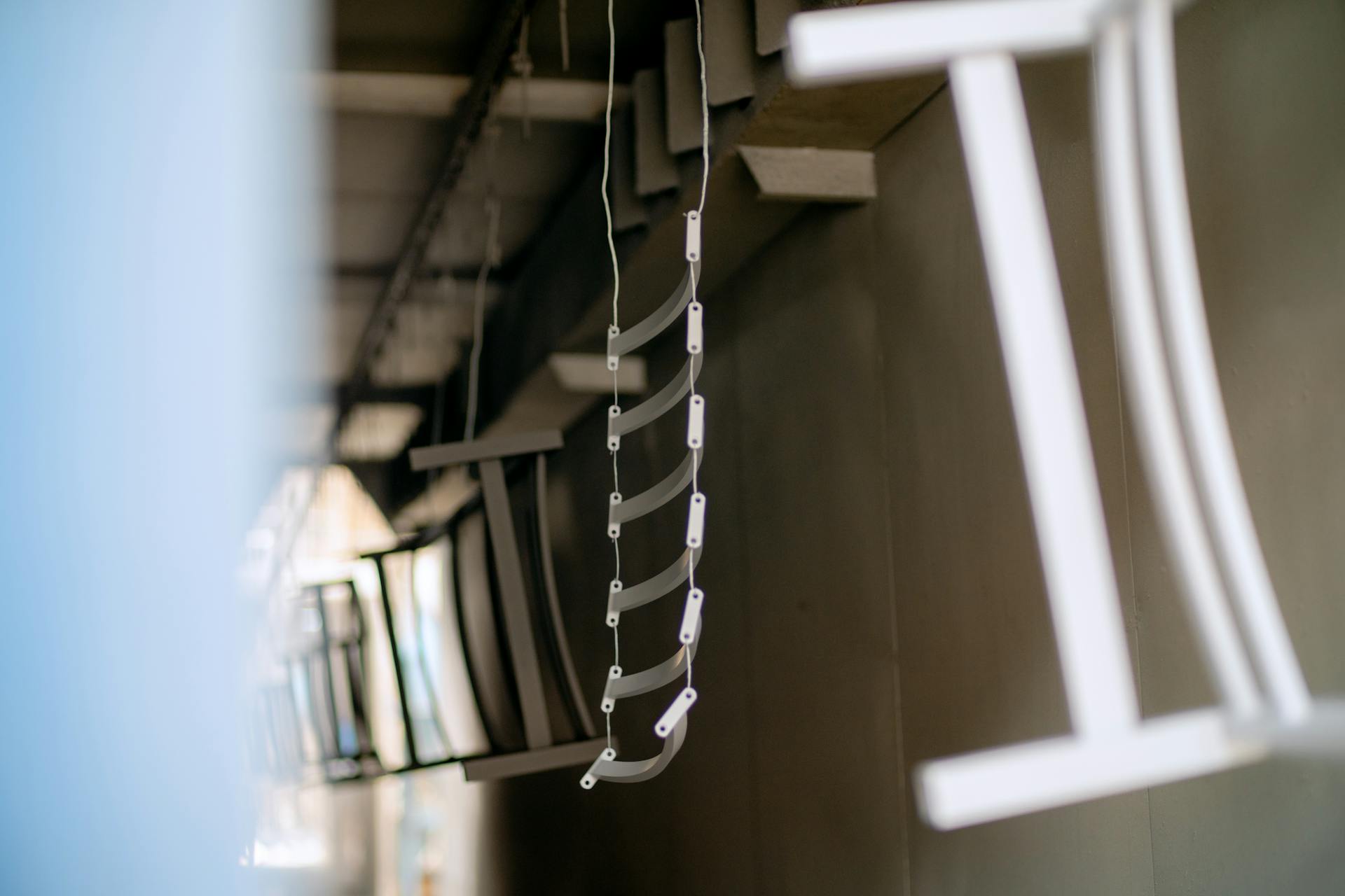 Close-up of industrial metal parts hanging in a coating process, showcasing manufacturing details.