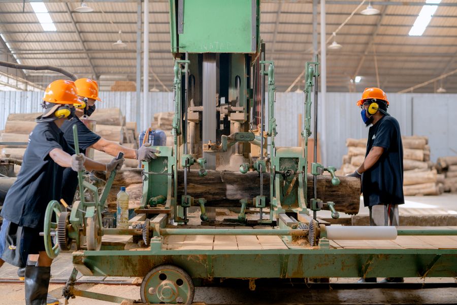 Workers handling lumber