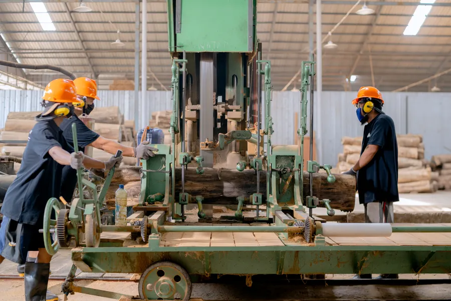 Workers handling lumber