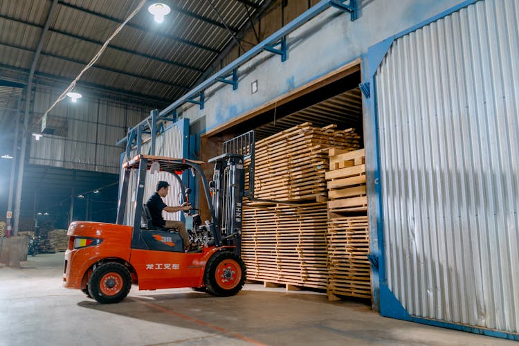 A Man Driving A Forklift