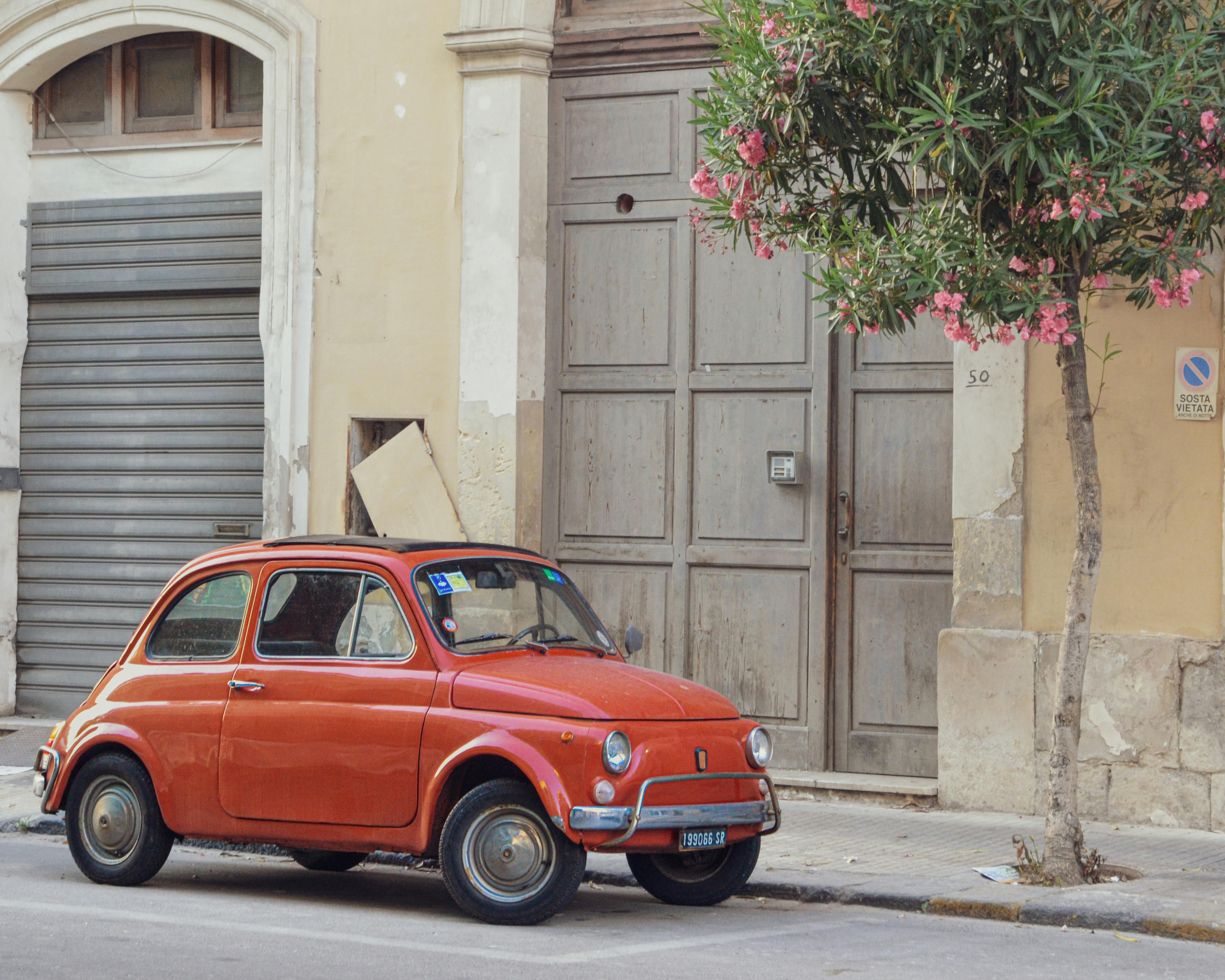 Fiat 500 Parked in Front of a Building on an Italian Street · Free