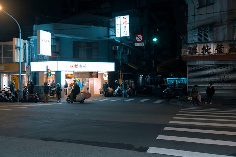 People On A Busy Street At Night