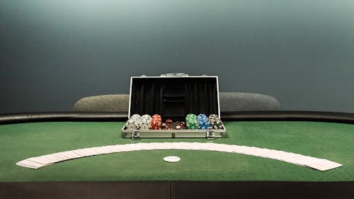 Box with Poker Chips on Table with Cards