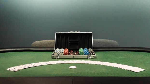 Poker table with colored chips and playing cards set for a game. Ideal for gambling themes.