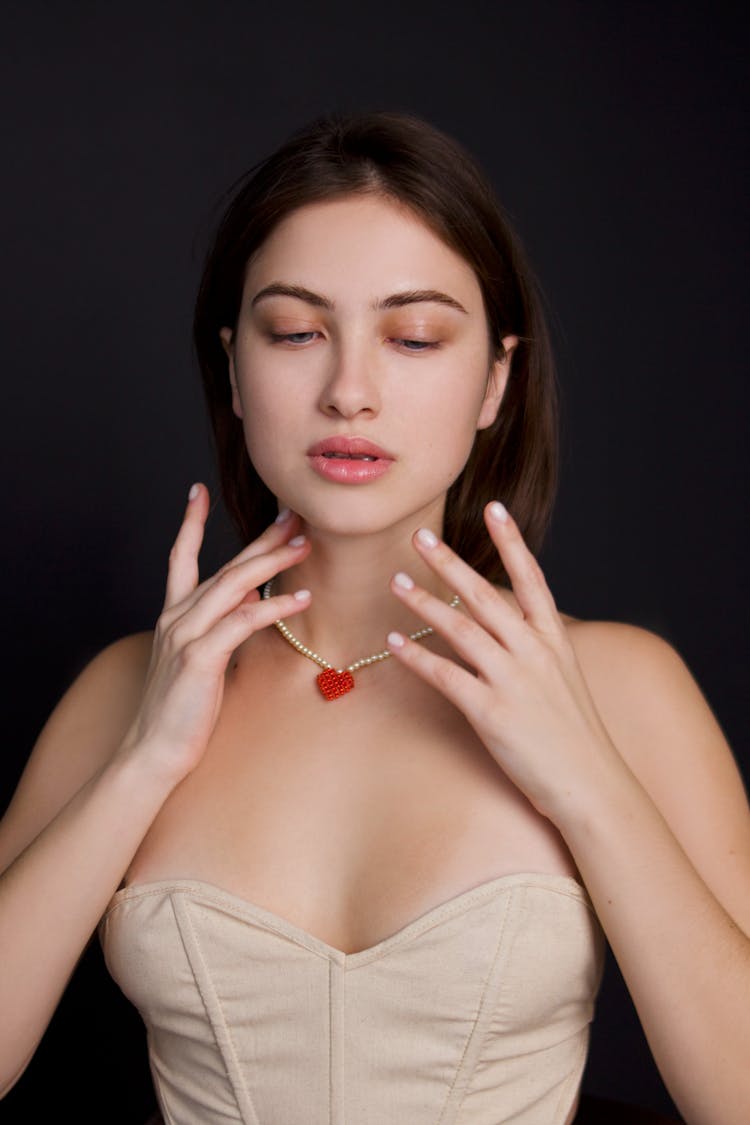 Young Woman Wearing A Heart Necklace 