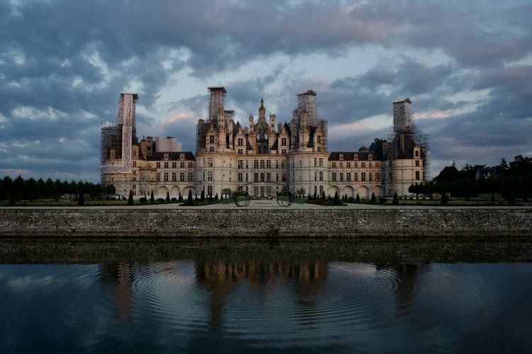 Chateau De Chambord Under A Dramatic Sky At Dusk 