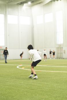 Group of athletes engaged in an indoor sports activity, capturing dynamic motion.