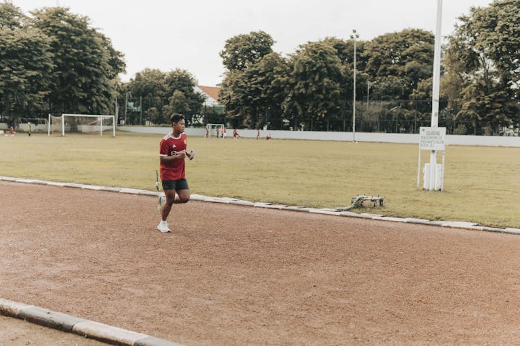 An Athlete Running On A Track