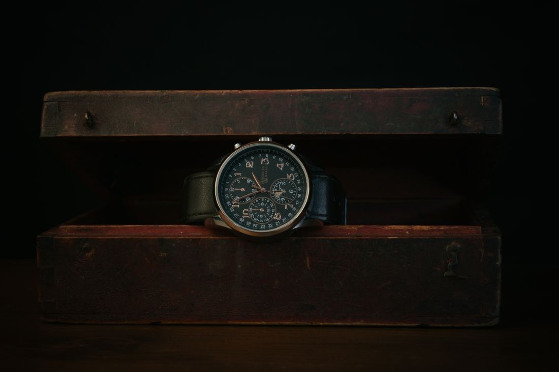 A chronograph resting in an aged wooden presentation box — photo by PonerMas s on Pexels