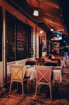 Charming outdoor dining area with tables and chairs set up on a vibrant evening patio