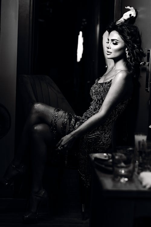 Grayscale Photo of a Woman in a Stylish Dress