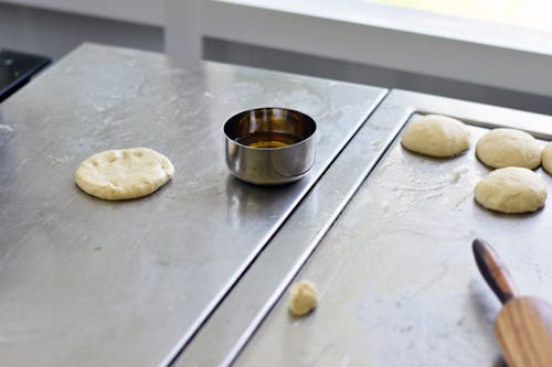 Cooking Pasty with Homemade Dough on Kitchen Steel Surface